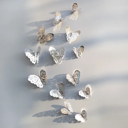 Set of 12 Hollow 3D Butterfly Wall Stickers: Decorative Decals in Gold and Silver for Wedding Decorations, Living Room, Windows, and Home Decor. Create a charming and elegant atmosphere with these butterfly decals.