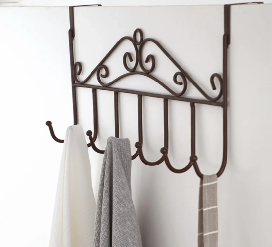Metal hanger bracket with 7 hooks for door or wall hanging. Ideal for clothes storage in the bedroom, kitchen, or bathroom. Organizer accessory.