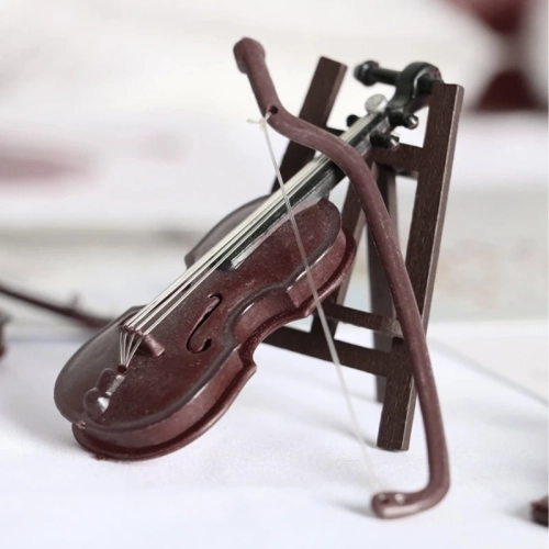 Miniature violin ornament with stand and case for home or office desktop decoration.