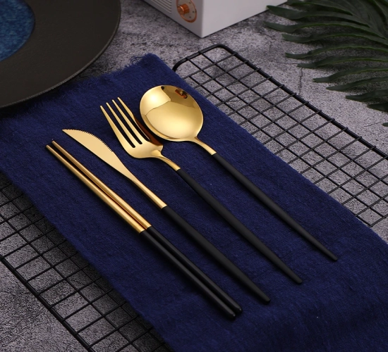 Chic 12-16 piece black and gold cutlery set. Stainless steel Korean dinnerware with chopsticks, knife, fork, and spoon for a luxurious table setting.