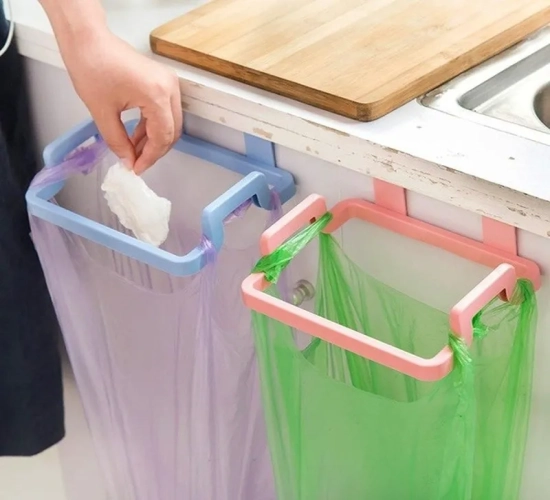Cabinet door-mounted trash rack for storage and holding garbage bags in the kitchen. Convenient organizer for kitchen rubbish.